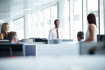 Buy stock photo Shot of a group of businesspeople talking together in an office