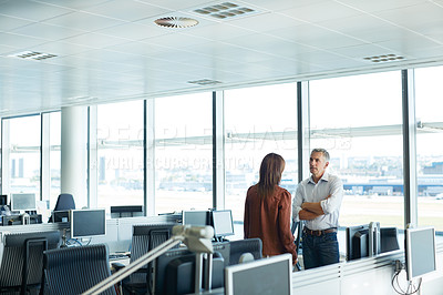 Buy stock photo Shot of two businesspeople talking together in an office