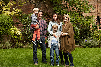 Buy stock photo Portrait of a smiling multigenerational family standing together outside