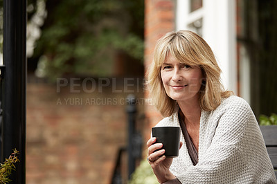 Buy stock photo Portrait of a mature woman sitting on her balcony drinking coffee