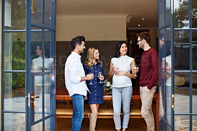 Buy stock photo Shot of a group of friends talking together at a dinner party