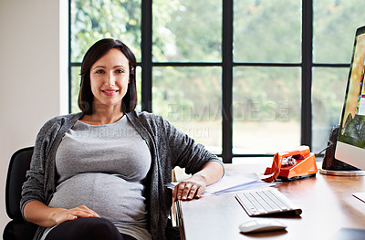 Buy stock photo Portrait of a pregnant woman sitting at a desk in her home office