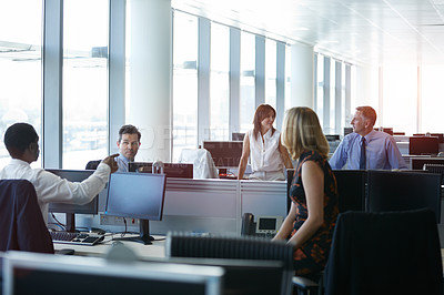 Buy stock photo Shot of a group of coworkers talking together in a modern office