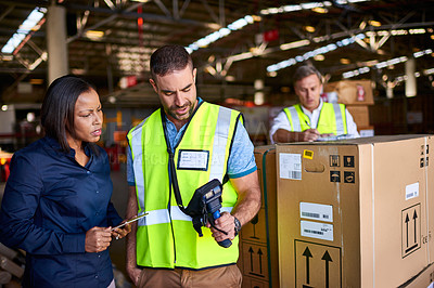 Buy stock photo Shot of workers talking together over a barcode reader inside of a warehouse