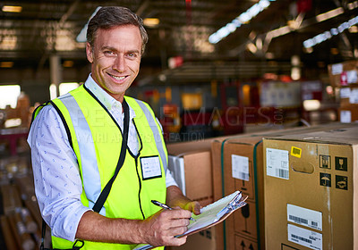 Buy stock photo Portrait of a warehouse worker standing in a large warehouse holding a clipboard