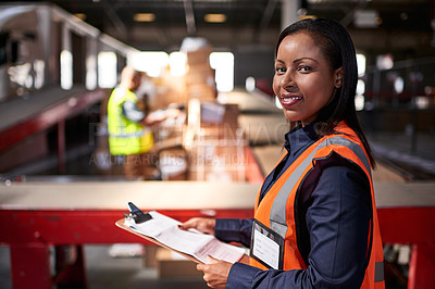 Buy stock photo Portrait of a warehouse manager holding a clipboard with workers in the background