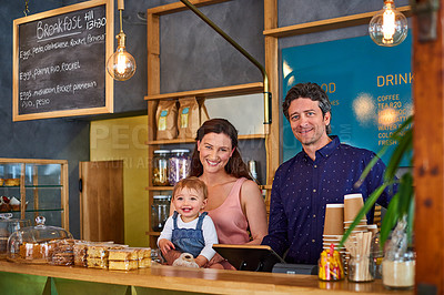 Buy stock photo Portrait of smiling couple and their little girl standing in their bakery