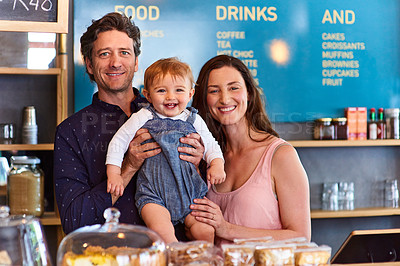 Buy stock photo Portrait of smiling couple and their little girl standing in their bakery