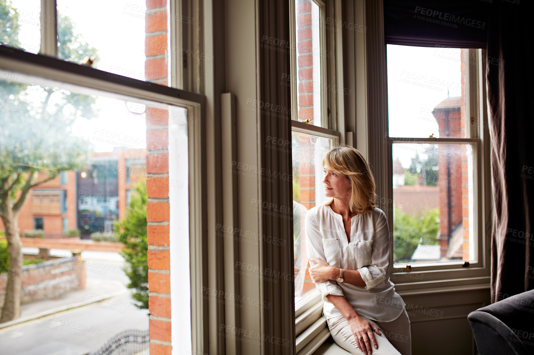 Buy stock photo Thinking, woman and relax at window with smile, vision and daydreaming for weekend unwind. Happy, mature person and comfortable in home with reflection, nostalgia memory and chilling for outdoor view