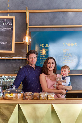 Buy stock photo Portrait of a smiling couple and their little girl standing in their bakery