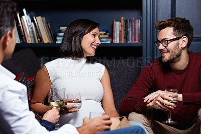 Buy stock photo Shot of a group of friends enjoying a night in together at home