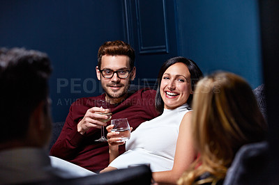 Buy stock photo Shot of a group of friends enjoying a night in together at home