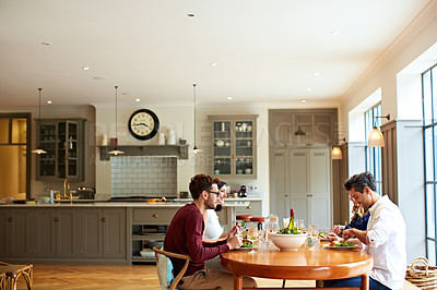 Buy stock photo Shot of a group of friends enjoying a home-cooked dinner together