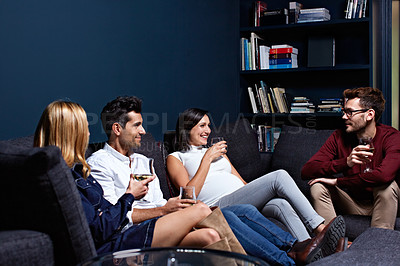Buy stock photo Shot of a group of friends enjoying a night in together at home