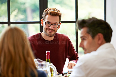 Buy stock photo Shot of a group of friends enjoying a home-cooked dinner together