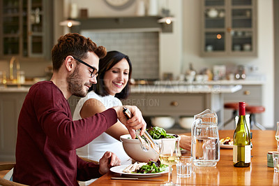 Buy stock photo Shot of a young couple having dinner together