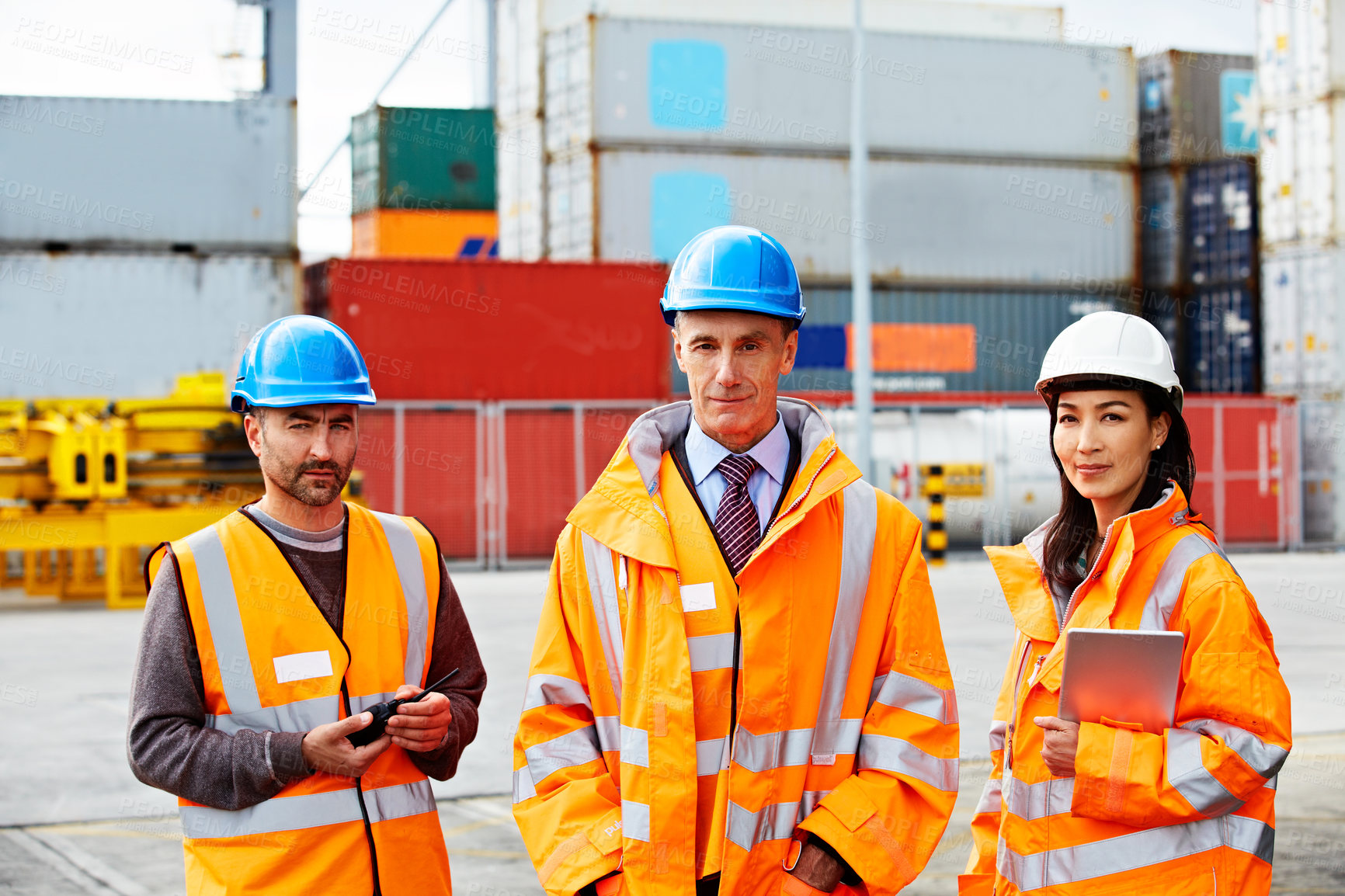 Buy stock photo Portrait of three workers standing on a commercial dock