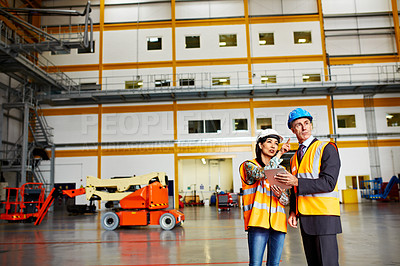 Buy stock photo Shot of two dock workers standing in a dockyard