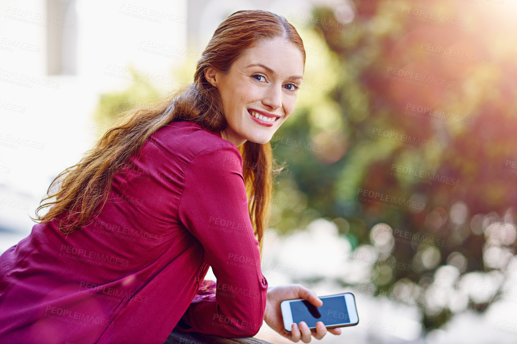 Buy stock photo Portrait of a young woman waiting for a call while standing outside