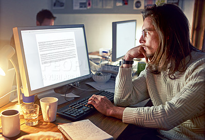 Buy stock photo Shot of a young designer working on a computer in an office