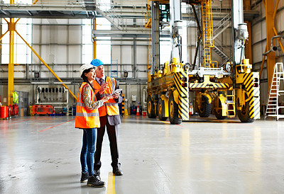 Buy stock photo Shot of two dock workers standing in a dockyard