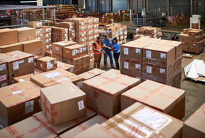 Buy stock photo Shot of people at work in a large warehouse full of boxes
