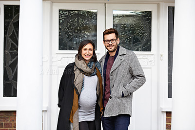 Buy stock photo Portrait of a pregnant woman and her husband standing on their front porch