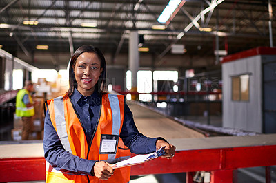 Buy stock photo Portrait of a warehouse manager holding a clipboard with workers in the background