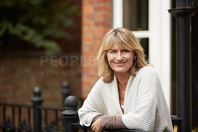 Buy stock photo Portrait of a mature woman leaning against the railing of her front porch