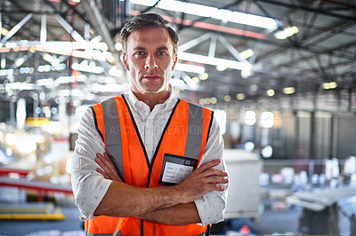 Buy stock photo Portrait of a warehouse worker standing with his arms crossed in a large warehouse