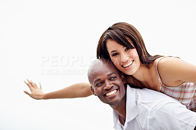 Buy stock photo Portrait of a man carrying his girlfriend on his shoulders while enjoying a day outside together