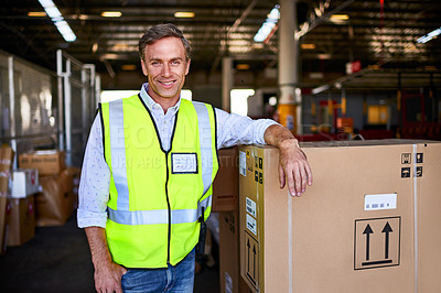 Buy stock photo Portrait of a warehouse worker standing next to boxes in a large warehouse