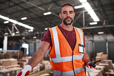 Buy stock photo Portrait of a worker holding a walkie talkie while standing in a large warehouse