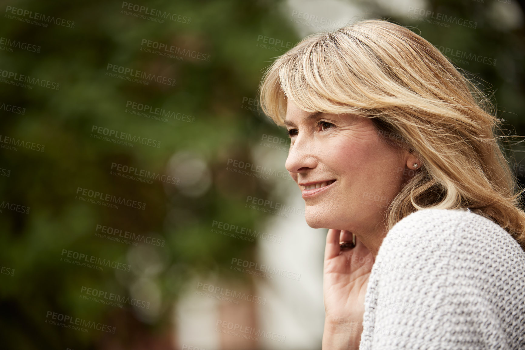 Buy stock photo Shot of a mature woman leaning deep in thought outside