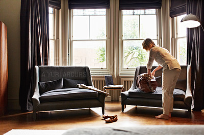 Buy stock photo Shot of a attractive mature woman packing for a business trip
