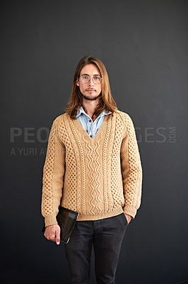 Buy stock photo Studio portrait of a young man holding a digital tablet against a gray background