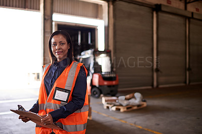 Buy stock photo Portrait of a worker standing in a warehouse holding a clipboard with workers a forklift in the background