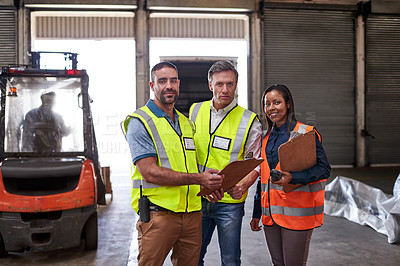 Buy stock photo Portrait of a group of coworkers holding clipboards while standing in a large warehouse