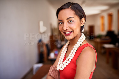 Buy stock photo Portrait of a smiling young woman standing with her arms crossed in an office