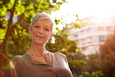 Buy stock photo Portrait of an attractive mature woman standing outside in the city