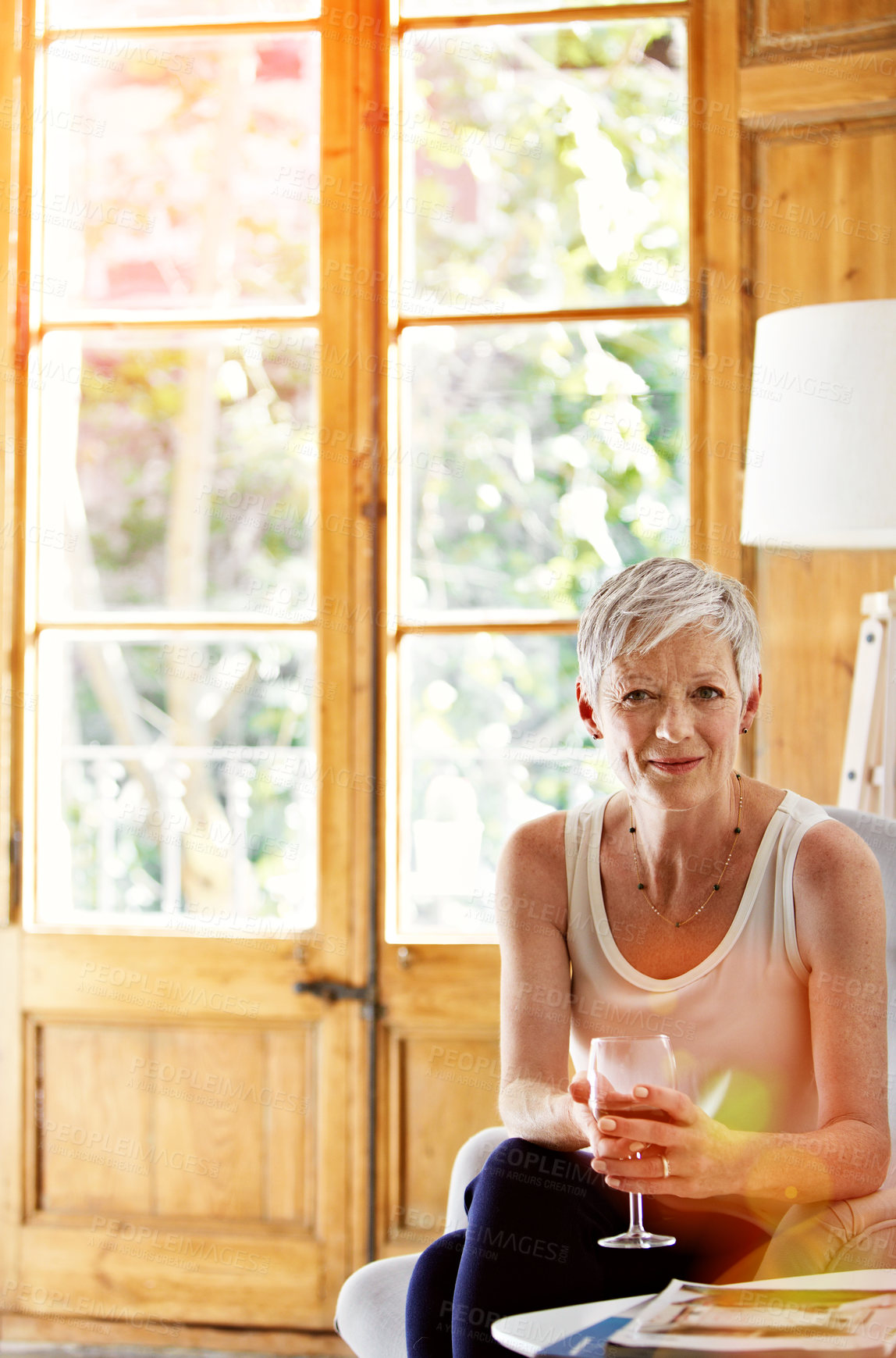 Buy stock photo Portrait, wine and peace with old woman on sofa in home for relax, weekend break and satisfaction. Happy, alcohol drink and glass with senior person and smile in living room in house for rest