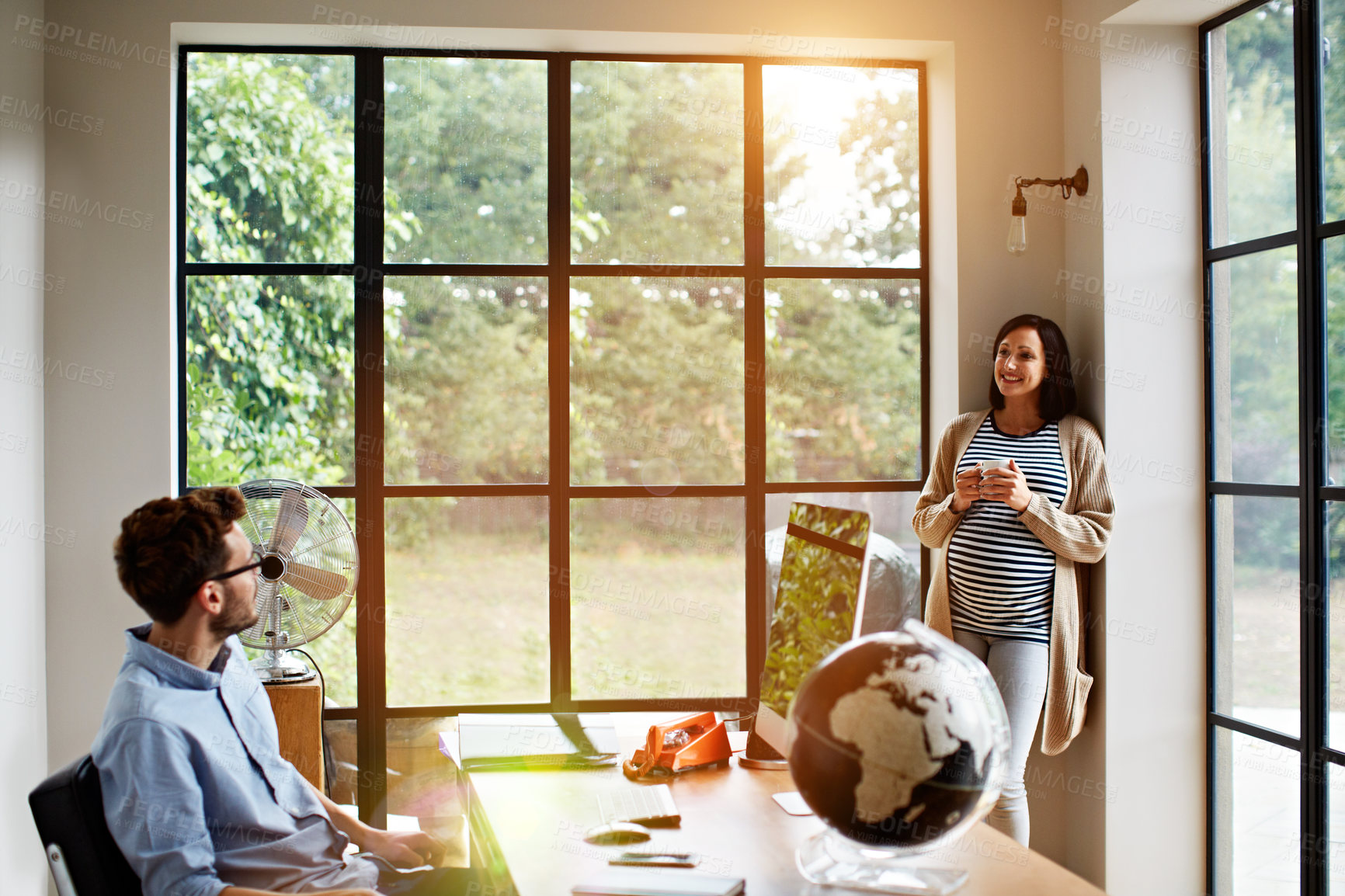Buy stock photo Coffee, pregnancy and remote work with couple in home office for small business planning. Conversation, drink and teamwork with happy freelance people in apartment together for development of startup