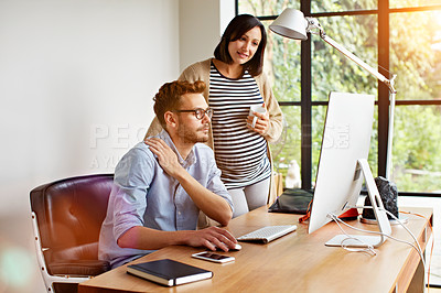Buy stock photo Shot of an expecting couple working together in their home office