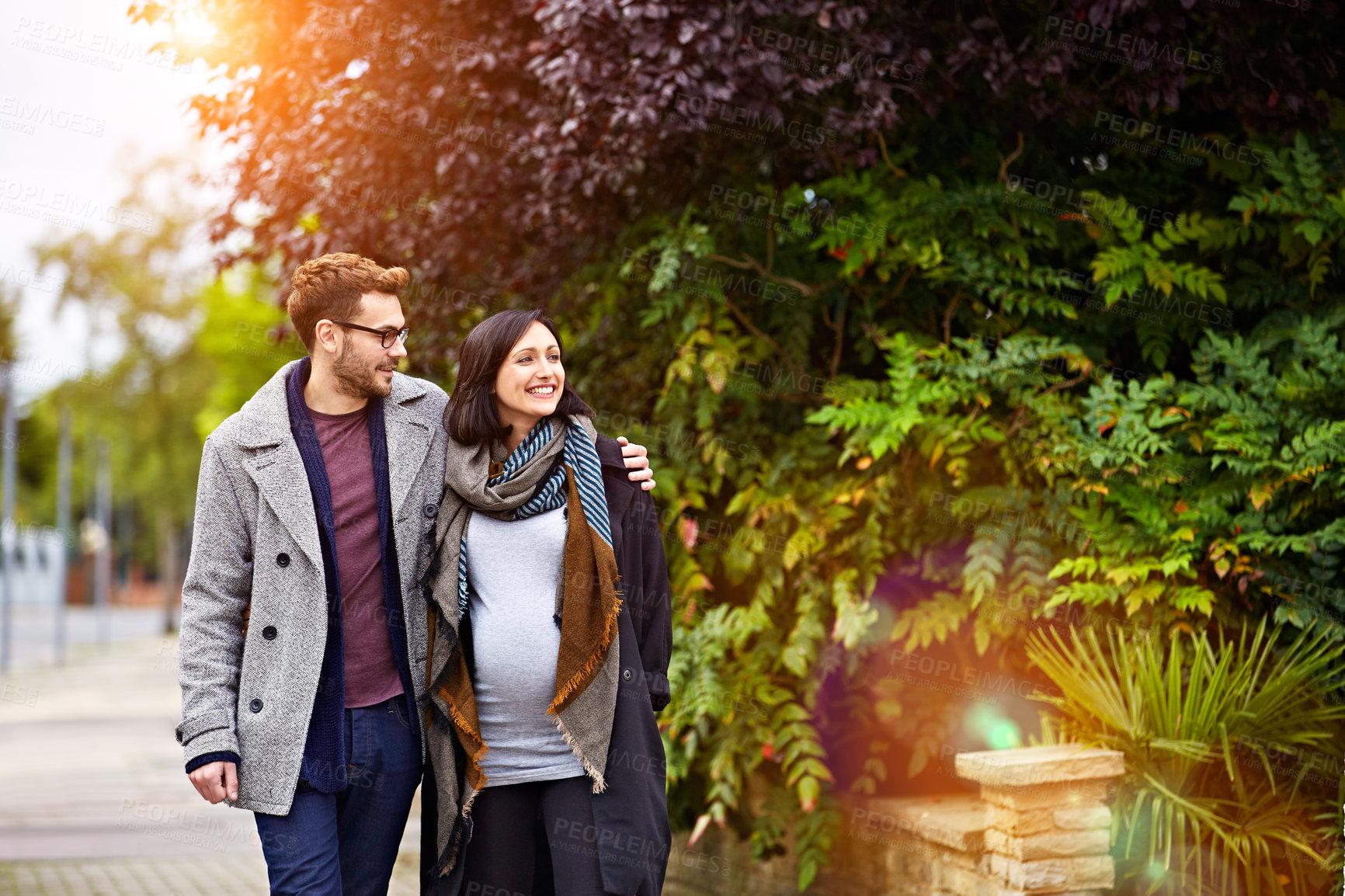 Buy stock photo Travel, pregnancy and happy couple outdoor on walk, love and bonding together with hug on vacation. Smile, man and pregnant woman at park on holiday trip, care or connection with future parents