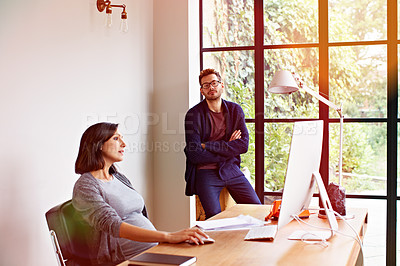 Buy stock photo Shot of an expecting couple working together in their home office