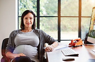 Buy stock photo Portrait of a pregnant woman sitting at a desk in her home office