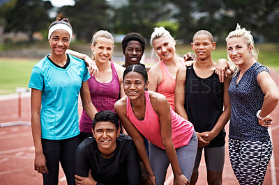 Buy stock photo Portrait of a group of friends in sports clothing standing on a running track