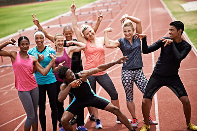 Buy stock photo Portrait of a group of carefree friends in sports clothing standing on a running track