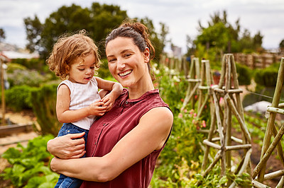 Buy stock photo Portrait of a mother with her little girl standing an organic garden
