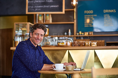 Buy stock photo Portrait of a smiling man working on a laptop in a cafe